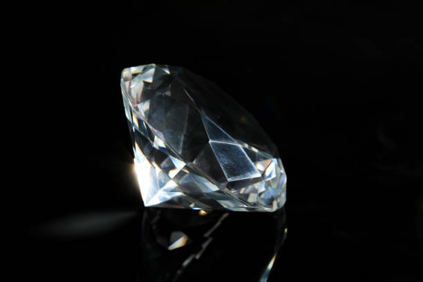 istock Beautiful dazzling diamond on black mirror background, closeup 1781006383
