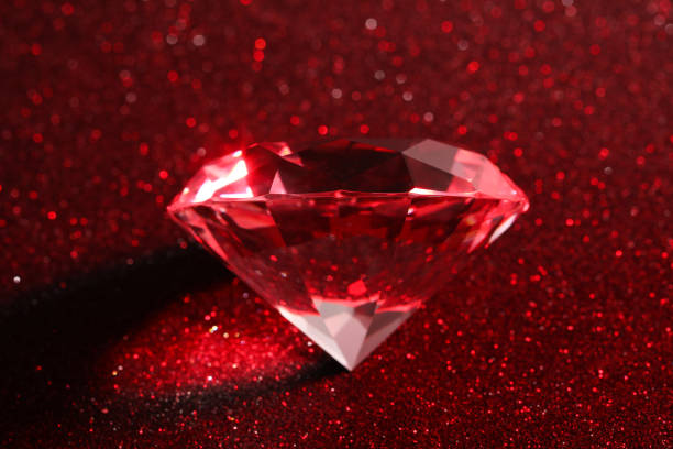 istock Beautiful shiny diamond on red glitter background 1781006944