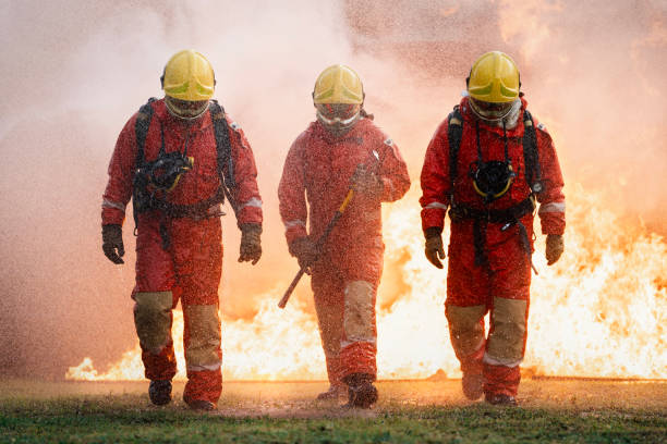 istock photo of three firefighters walking confidently back after extinguishing a fire 1781010594