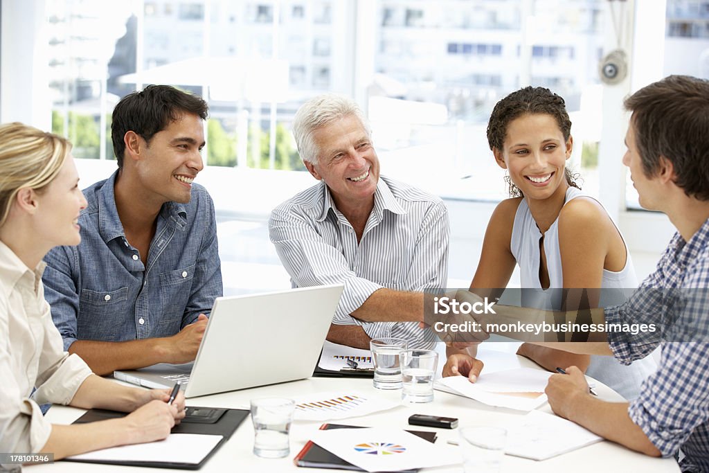 Mixed group in business meeting Mixed group in business meeting having a discussion shaking hands Business Stock Photo