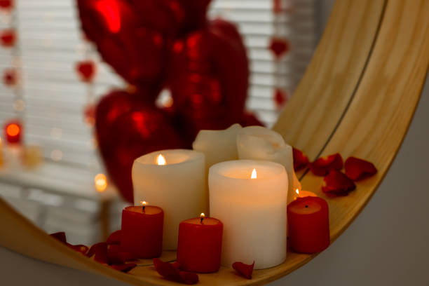 istock Mirror and burning candles in bathroom decorated for Valentine's day, closeup 1781014432