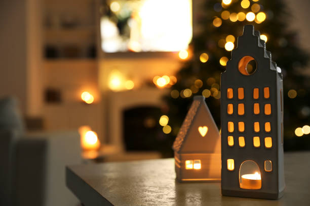 istock Beautiful house shaped candle holders on table indoors, space for text. Bokeh effect 1781014577
