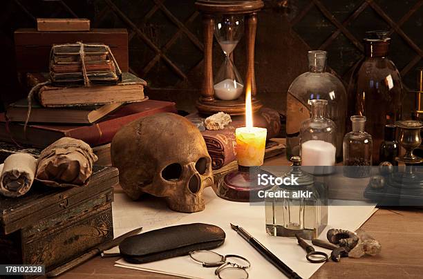 A Still Life Photo Of An Alchemists Desk Stock Photo - Download Image Now - Alchemy, Old Book, Gothic Style