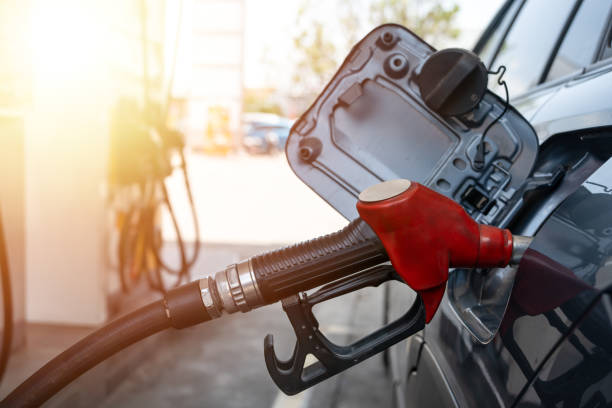 Filling gun inserted into the hole of a gasoline tank.
