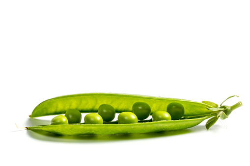 Ripe green peas on a white background, after assembly on the farm