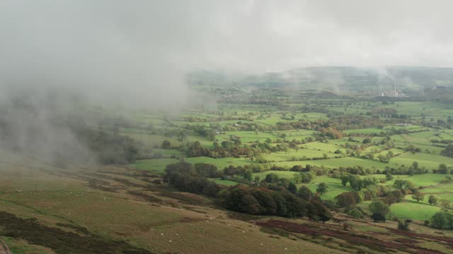 British rural landscape, green fields, low clouds with partial sun. English Autumn in the Peak District
