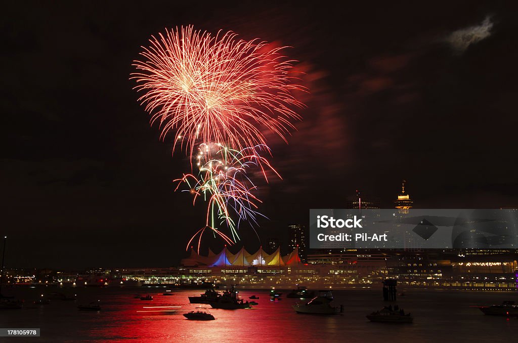 Red Yellow Green Purple Fireworks Vancouver Harbor Red, yellow, green, purple fireworks on Canada Day in Vancouver Harbor with boats and a part of the skyline. Canada Day Stock Photo