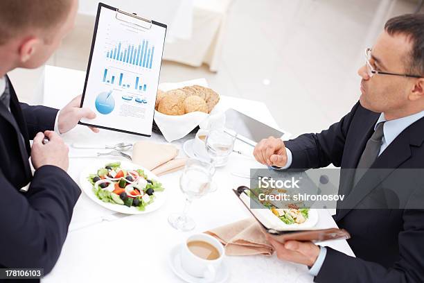 Discussing Paper At Lunch Stock Photo - Download Image Now - Adult, Appetizer, Bread