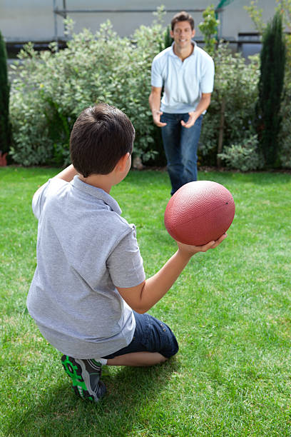 istock Father and son playing american football 178106776