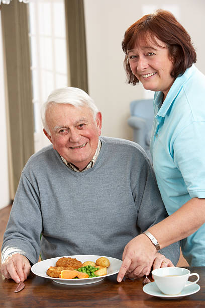 istock Senior Man Being Served Meal By Carer 178109604