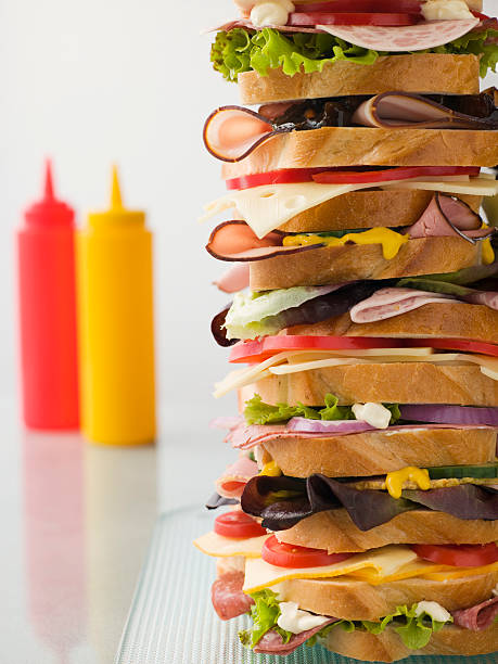 Dagwood Tower Sandwich With Sauces Dagwood Tower Sandwich With Sauces In Background dagwood stock pictures, royalty-free photos & images