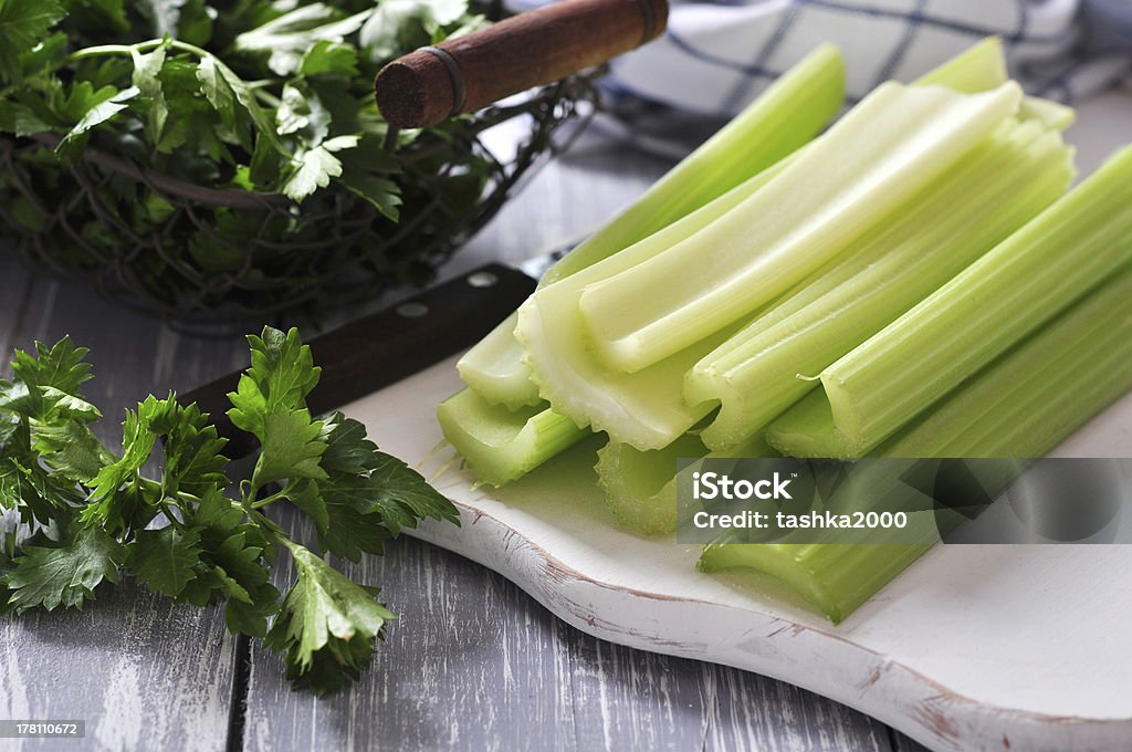 Celery stems Fresh green celery stems on wooden cutting board closeup Basket Stock Photo