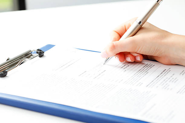 istock Businesswoman writing on a form 178112393