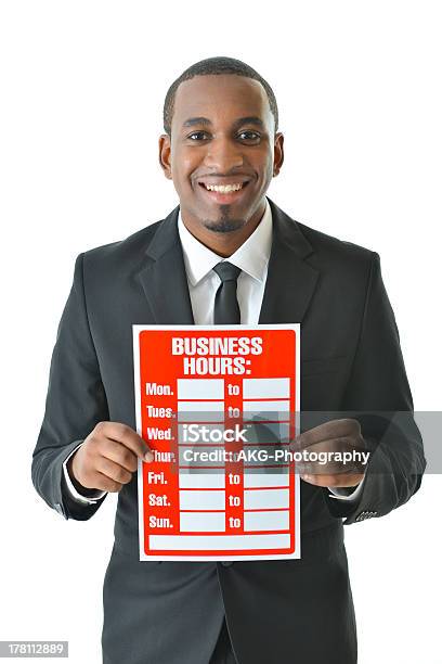 Foto de Homem Com A Placa De Horário De Negócios e mais fotos de stock de Agenda pessoal - Agenda pessoal, Autoridade, Branco