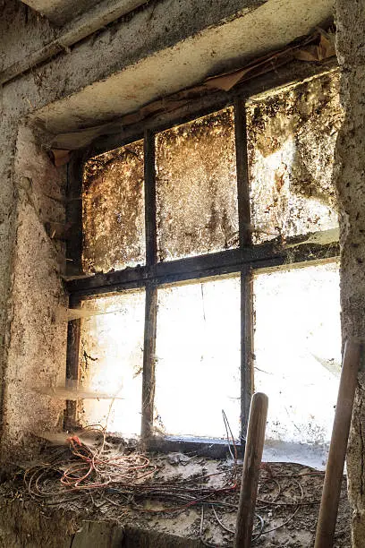 Old window with stains and cobwebs