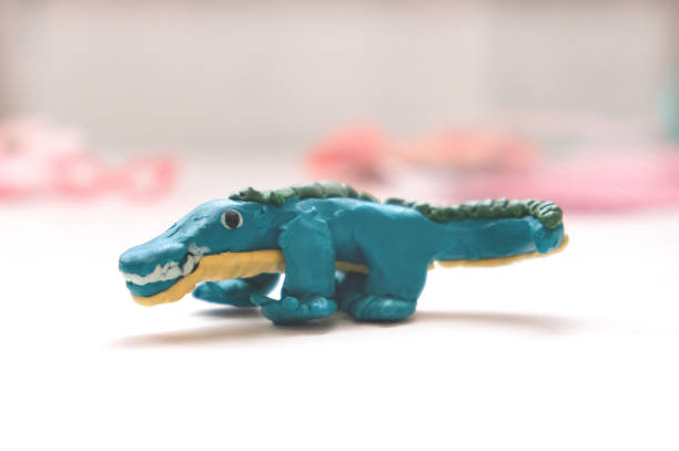 istock Child create funny animal, crocodile, alligator from plasticine, colorful modeling clay. Education, playing with clay, sensory perception. Inspiration, imagination 1781133605