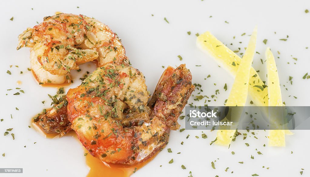 prawn appetizer for two macro photograph of a prawn dish decorated with lemon Al Ajillo Stock Photo