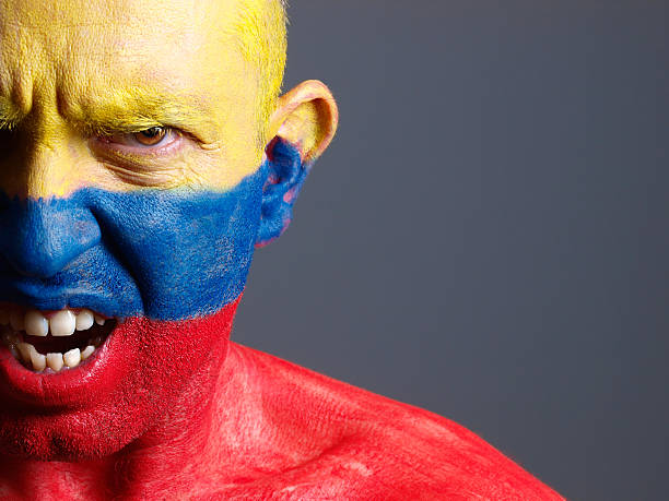 istock Man face painted with colombian flag, angry expression. 178115699