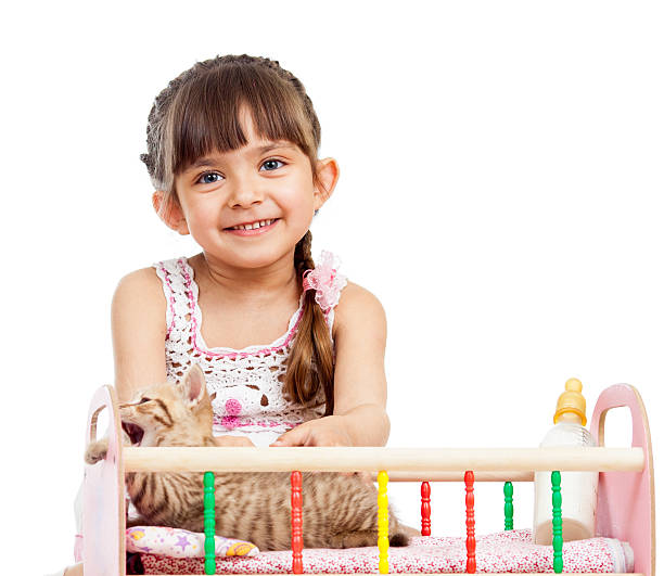 istock child girl playing with kitten 178115917