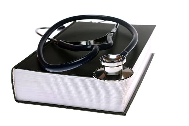 istock Stethoscope and book isolated on white background 178116645