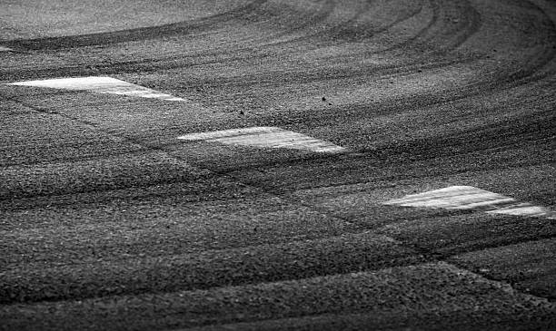 istock Abstract turning road background with tires track and triangle signs 178118011