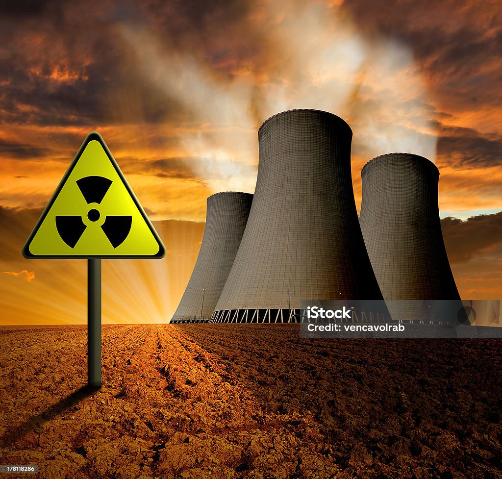 nuclear power plant Sunset over the nuclear power plant Agricultural Field Stock Photo