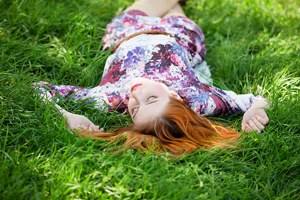 istock Beautiful girl lying down at grass. 178118339