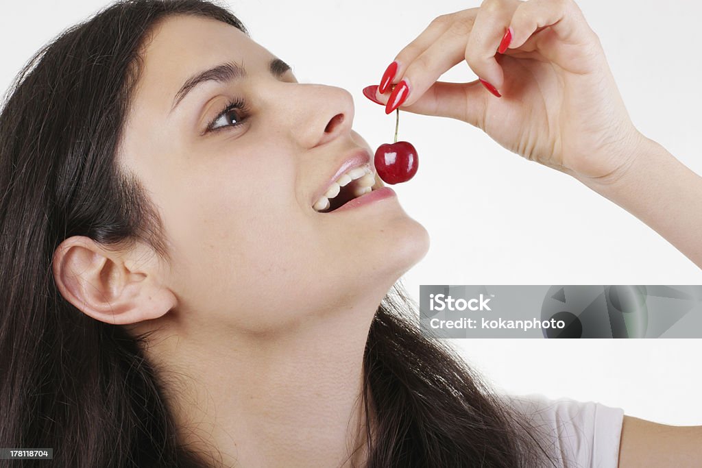 Girl eating cherries Beautfiul girl eating cherries Adult Stock Photo