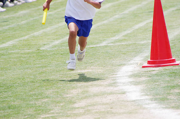 istock Japanese boy running in a relay race on a grass track 178118853