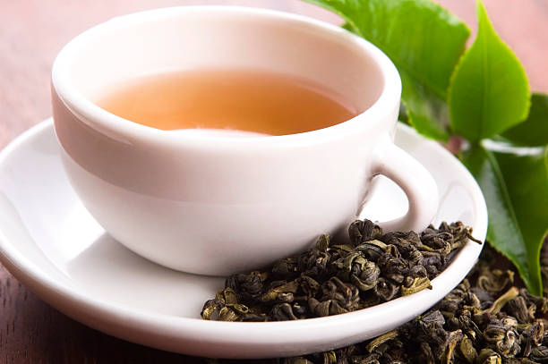 istock cup of green tea with freh leaves 178121139
