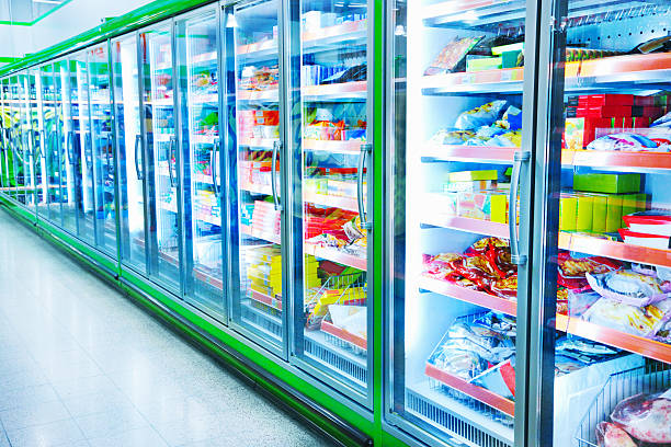 Refrigerators with products in supermarket Various products in a supermarket refrigerated section supermarket photos stock pictures, royalty-free photos & images