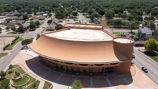 Bartlesville, Oklahoma, USA - June 25, 2023: Afternoon sunlight shines on the Bartlesville Community Center.