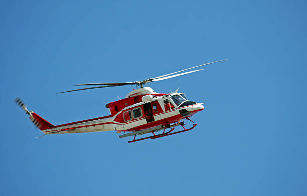 istock patrol helicopter of firefighters in blue sky over a fire 178123312