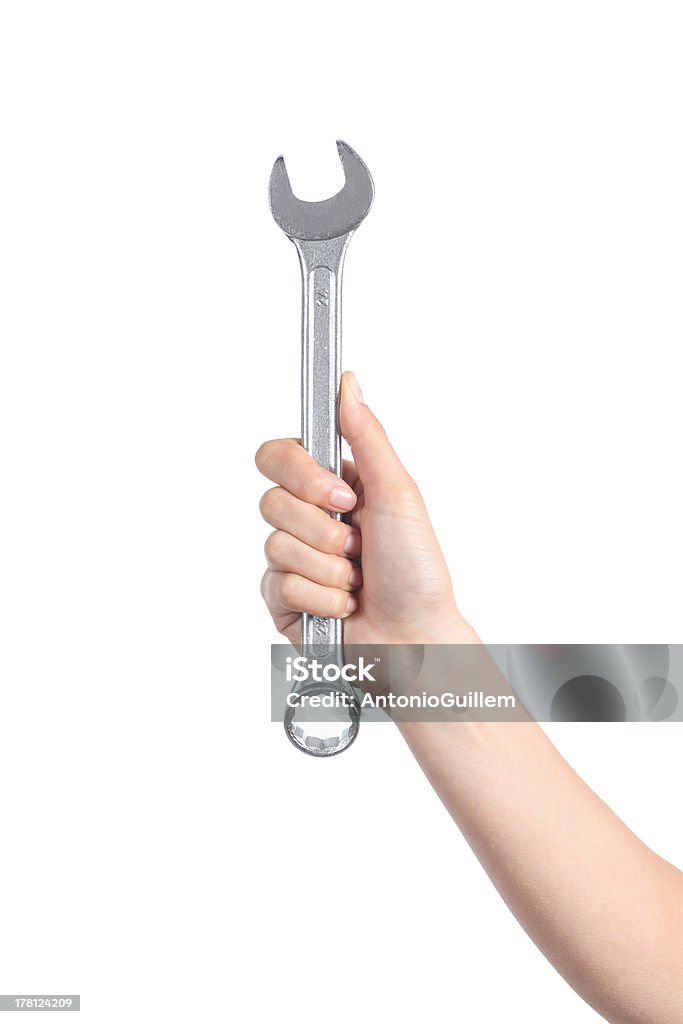 Woman hand holding a wrench Woman hand holding a spanner isolated on a white background Wrench Stock Photo