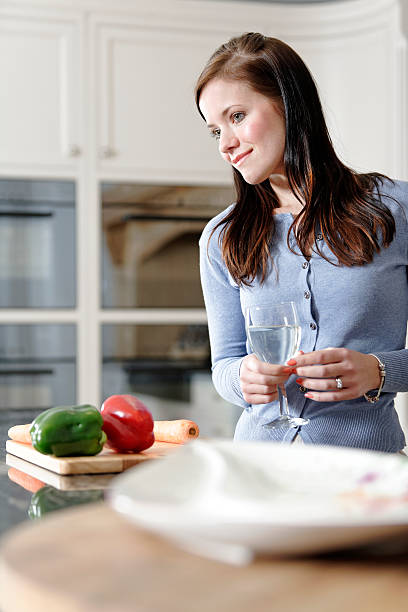 istock Woman preparing a meal in the kitchen 178124477