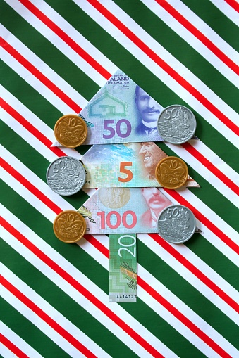 Christmas tree made from NZD New Zealand Dollars for a Saving for / the cost of Christmas concept.