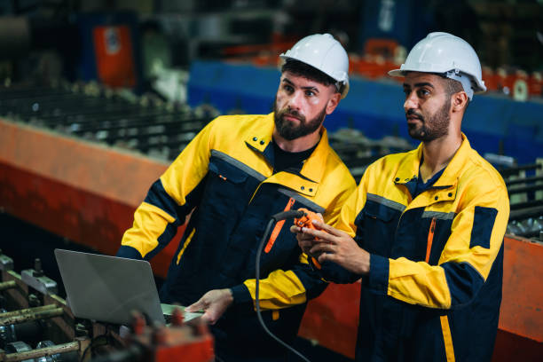 istock Industrial worker inspecting with laptop machine at factory machines. Technician working in the metal sheet company. 1781246861