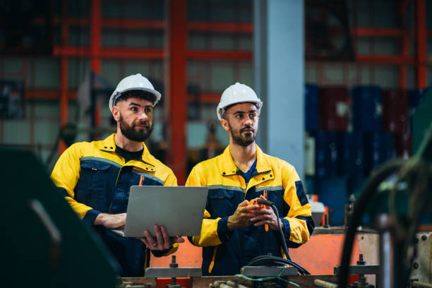 istock Industrial worker inspecting with laptop machine at factory machines. Technician working in the metal sheet company. 1781248439