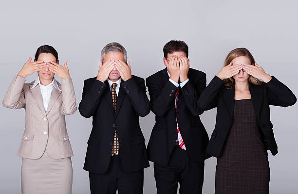 istock Four businesspeople holding their eyes shut 178124994