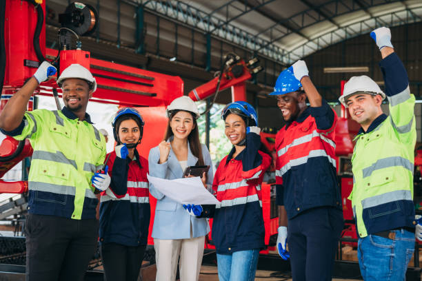 istock Team engineers and foreman stack hand and shake hands to show success at factory machines. Worker industry join hand for collaboration. 1781257544
