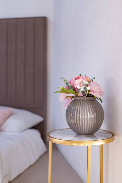 istock A vase standing on a marble table near the bed. Minimalism . Scandinavian interior. copy space.Decorations of a residential apartment 1781258071