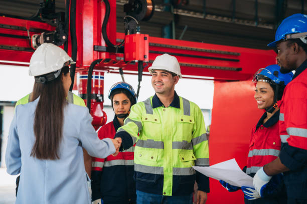 istock Team engineers and foreman stack hand and shake hands to show success at factory machines. Worker industry join hand for collaboration. 1781259122