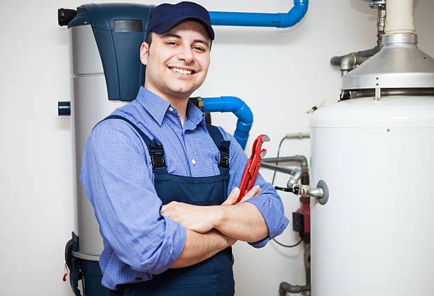Hot-water heater service Technician servicing an hot-water heater electric heater photos stock pictures, royalty-free photos & images