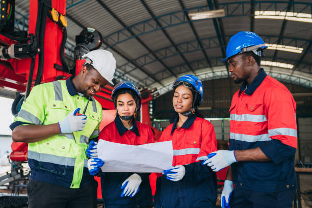 istock Engineers and foreman inspecting and meeting about the automated arms machine welding robots at factory machines. Worker industry working in the manufacture industrial. 1781262320