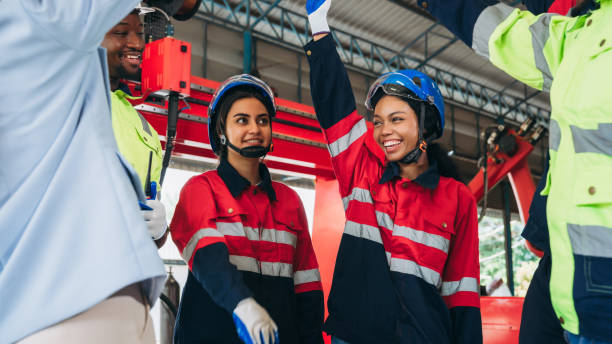 istock Team engineers and foreman stack hand and shake hands to show success at factory machines. Worker industry join hand for collaboration. 1781262836