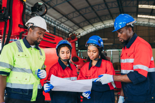 istock Engineers and foreman inspecting and meeting about the automated arms machine welding robots at factory machines. Worker industry working in the manufacture industrial. 1781263385