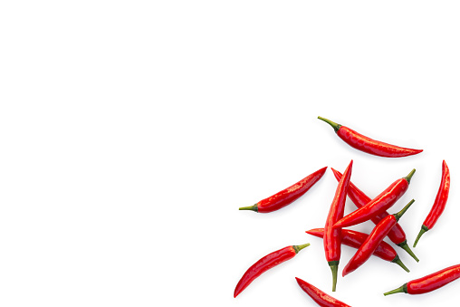 Closeup of fresh organic red chilli pepper from the garden isolated on a white background from above, top view