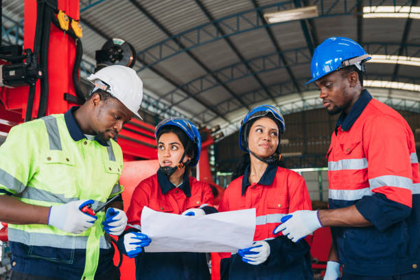 istock Engineers and foreman inspecting and meeting about the automated arms machine welding robots at factory machines. Worker industry working in the manufacture industrial. 1781268387