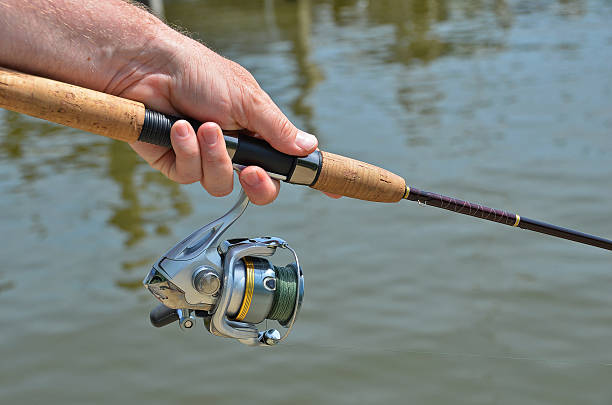 istock man holding a fishing pole 178128263