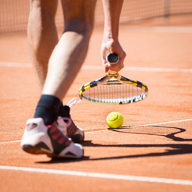 istock man catchs ball with his racket from court 178128782